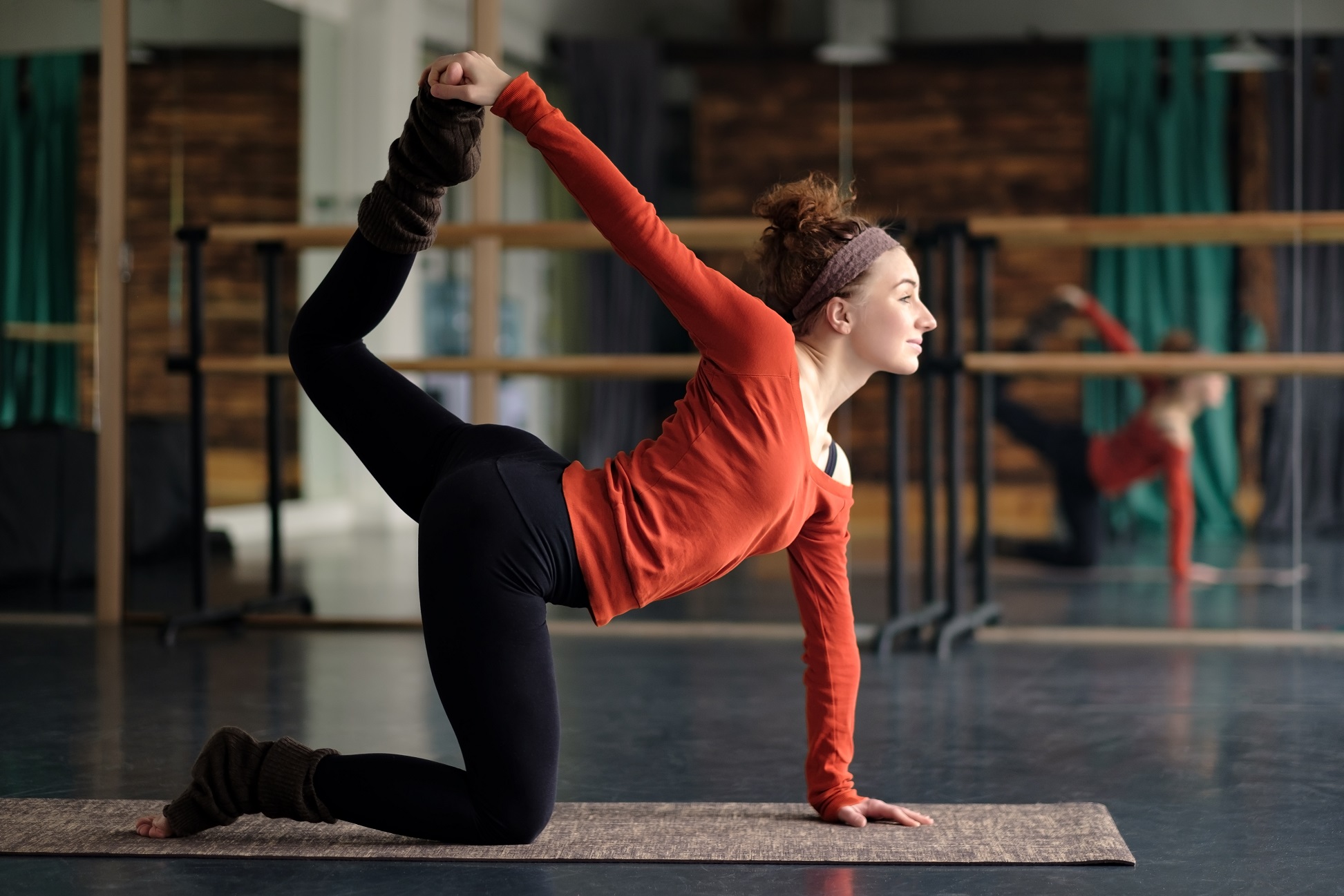 Young woman practicing yoga, stretching in Bird dog exercise, tiger pose, working out. Indoor full length